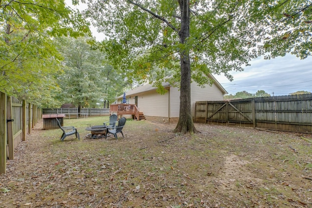 view of yard featuring a fire pit and a deck