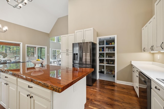 kitchen featuring white cabinets, appliances with stainless steel finishes, and an inviting chandelier