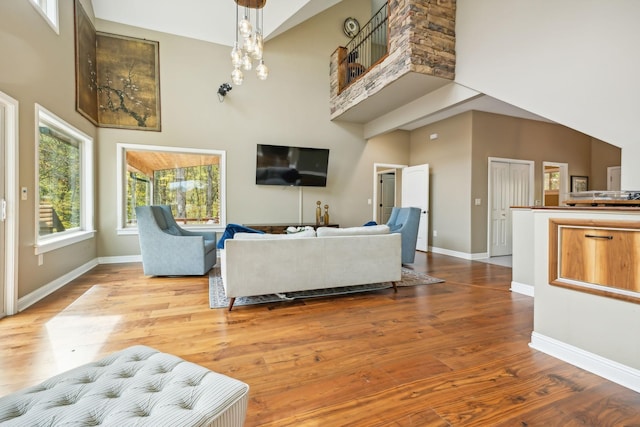 living room featuring hardwood / wood-style floors and a towering ceiling