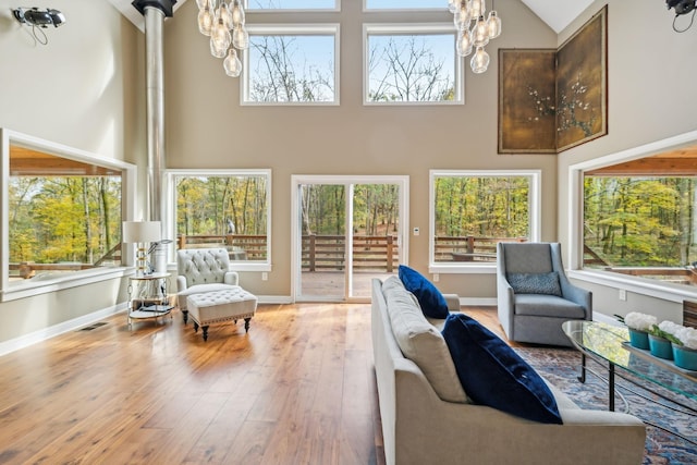 sunroom / solarium featuring a chandelier