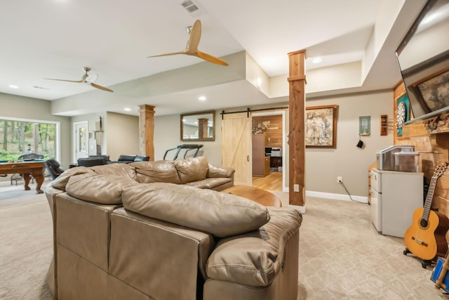 carpeted living room featuring a barn door, ornate columns, ceiling fan, and pool table