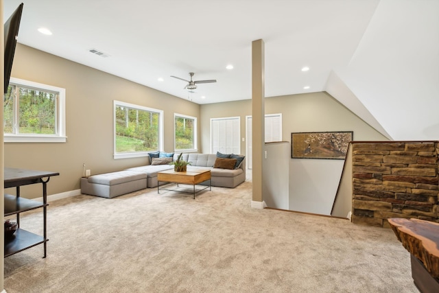 living room with ceiling fan, light colored carpet, and vaulted ceiling