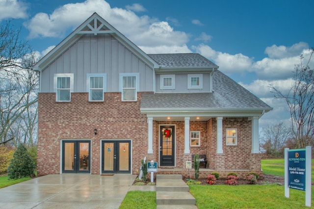 view of front of home with a front yard and french doors