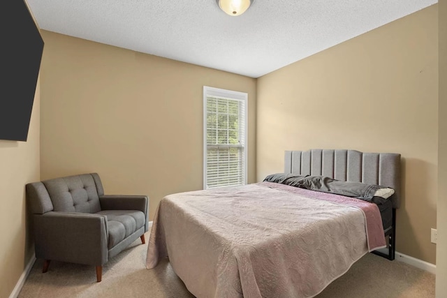 carpeted bedroom featuring a textured ceiling