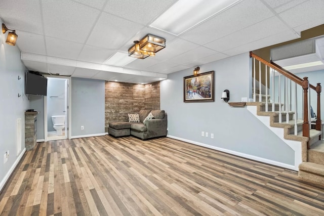 unfurnished room with hardwood / wood-style floors and a paneled ceiling