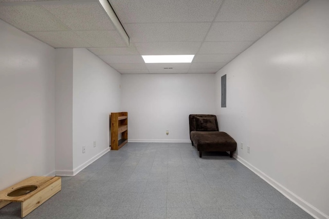 unfurnished room with a paneled ceiling and electric panel