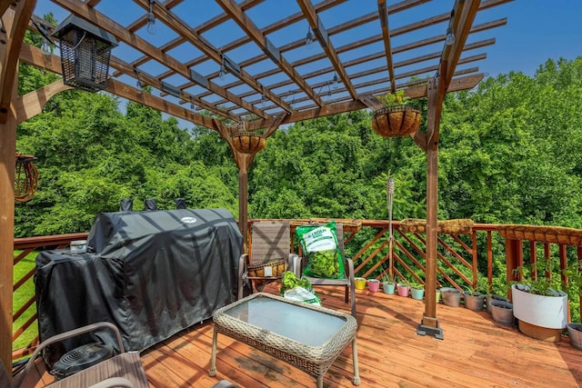 wooden deck featuring a pergola and area for grilling