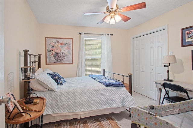 carpeted bedroom featuring ceiling fan and a closet