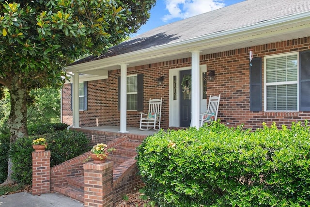 view of exterior entry featuring a porch