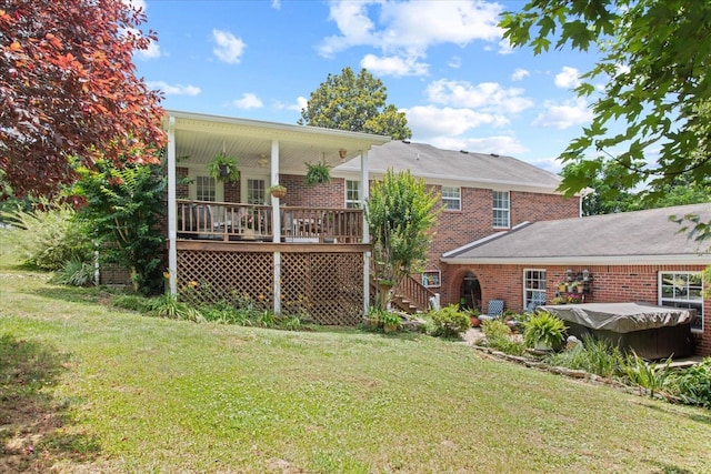 rear view of house featuring a yard