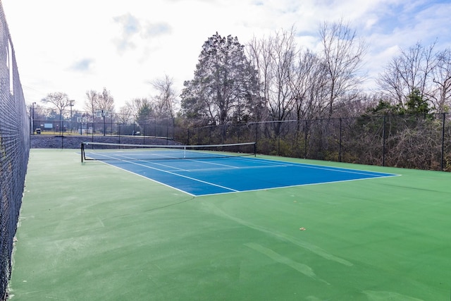 view of tennis court featuring basketball hoop