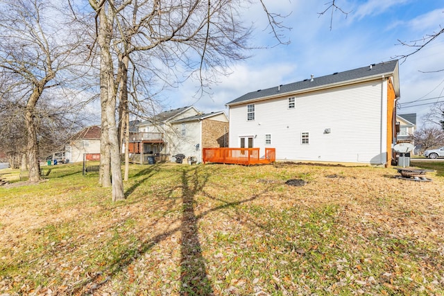 back of house with a yard and a wooden deck