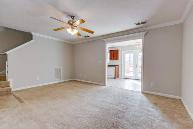 unfurnished living room with ceiling fan with notable chandelier, light colored carpet, and crown molding