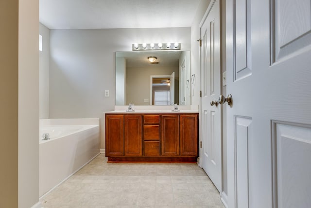 bathroom with a washtub and vanity