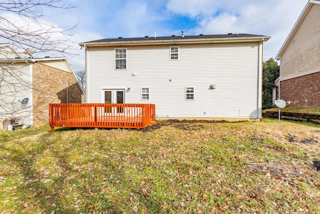 rear view of house with a yard and a deck