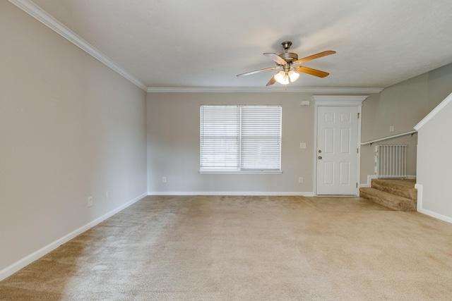 unfurnished living room featuring light carpet, crown molding, and ceiling fan