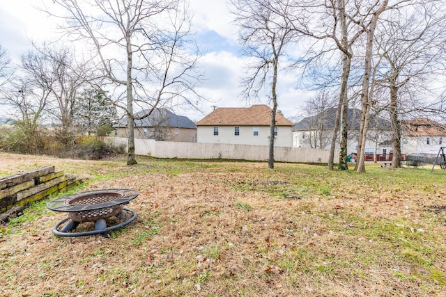 view of yard with a fire pit