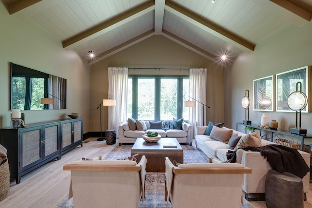 living room with light hardwood / wood-style floors, beam ceiling, and high vaulted ceiling