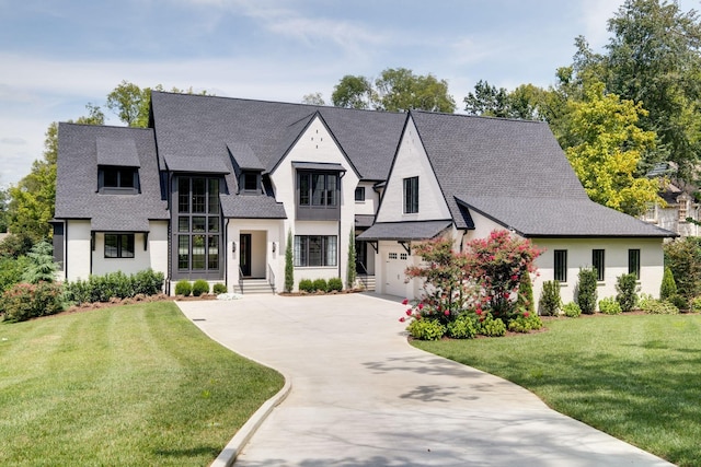 view of front of property with a front yard and a garage