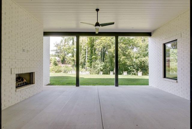 view of patio featuring ceiling fan and an outdoor brick fireplace