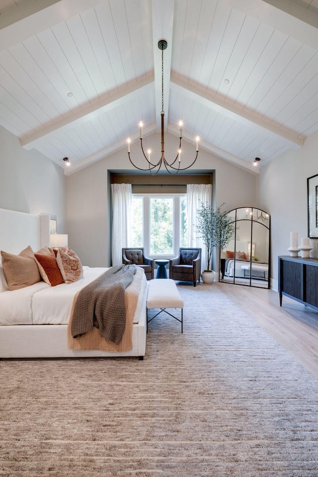 bedroom with lofted ceiling with beams and an inviting chandelier