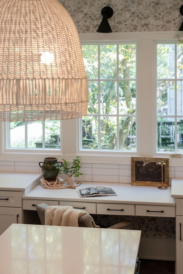 kitchen featuring backsplash and white cabinetry