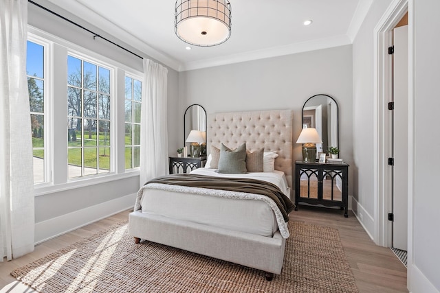 bedroom with hardwood / wood-style flooring and crown molding