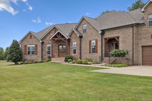 view of front of home featuring french doors, a front yard, and a garage