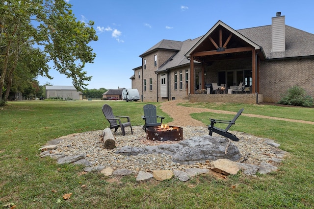 exterior space featuring a patio and an outdoor fire pit