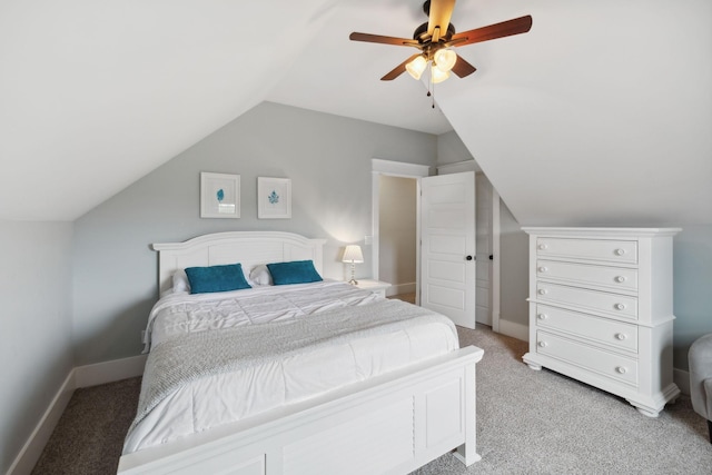 bedroom featuring ceiling fan, light colored carpet, and vaulted ceiling