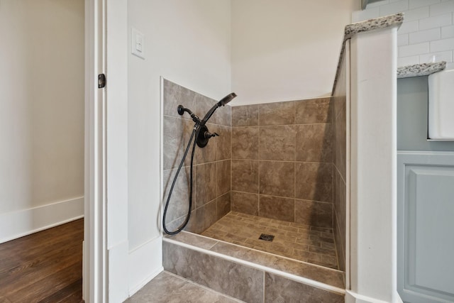 bathroom with tiled shower