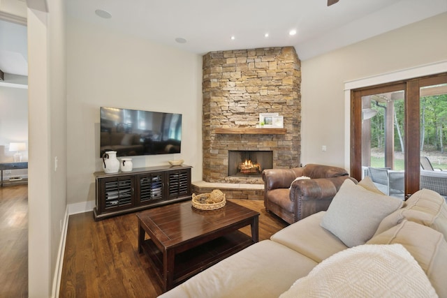 living room featuring a fireplace, dark hardwood / wood-style flooring, and vaulted ceiling