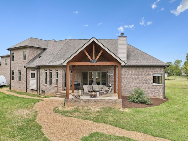 back of property featuring a lawn, a patio area, and an outdoor living space