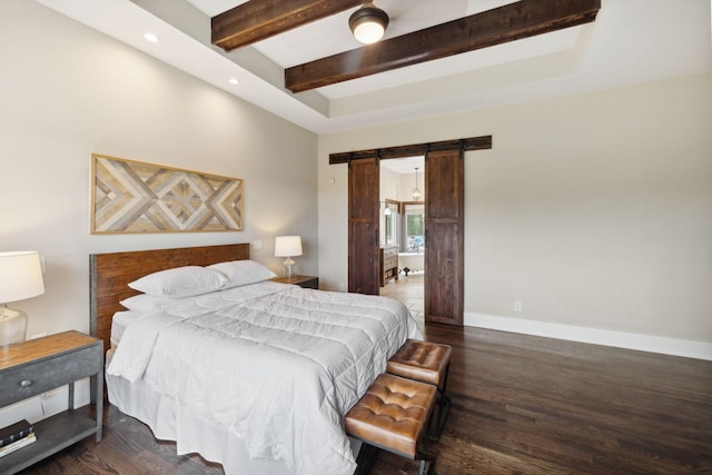 bedroom with a barn door and dark wood-type flooring