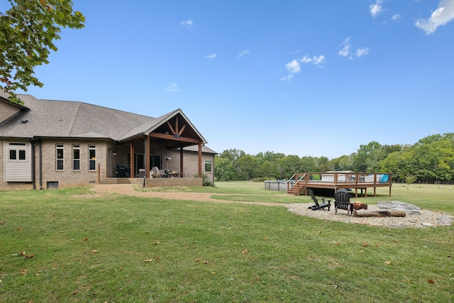 view of yard with an outdoor fire pit and a wooden deck