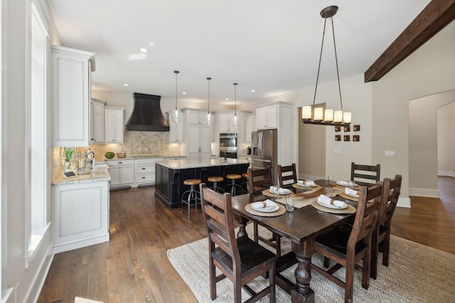 dining room with beam ceiling and dark wood-type flooring