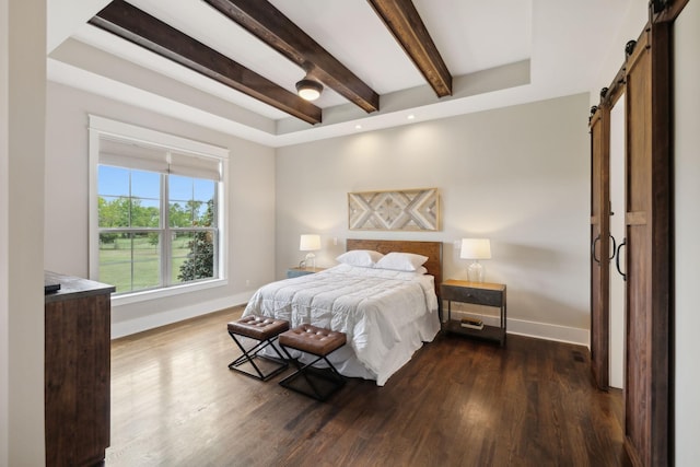 bedroom featuring a barn door and dark hardwood / wood-style flooring