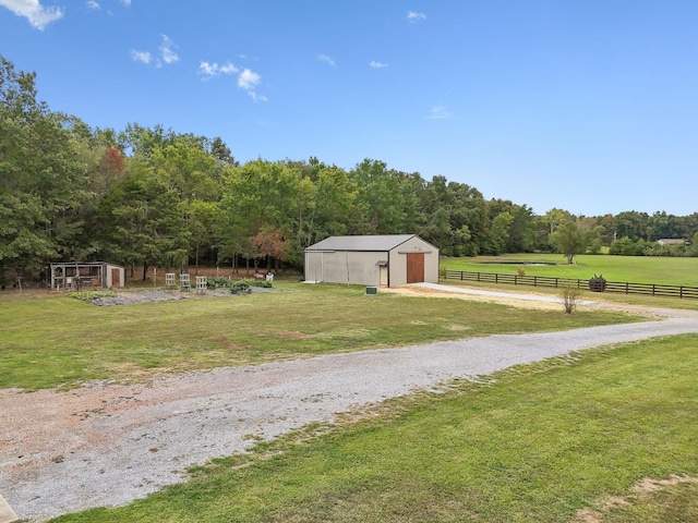 view of yard featuring a rural view and an outdoor structure