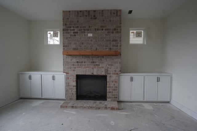 unfurnished living room featuring a wealth of natural light and a fireplace