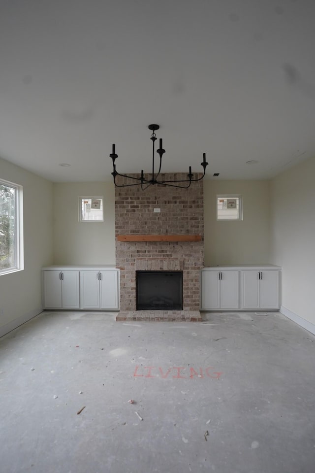 unfurnished living room featuring a brick fireplace