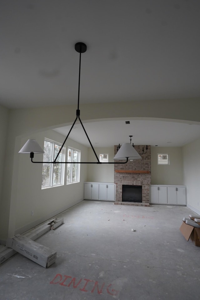 unfurnished living room featuring a stone fireplace