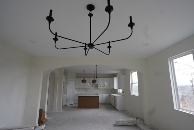 kitchen featuring a healthy amount of sunlight, a center island, and white cabinets