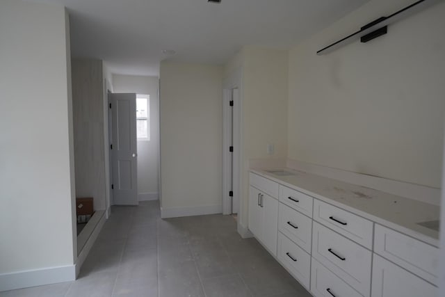 hall featuring light tile patterned flooring