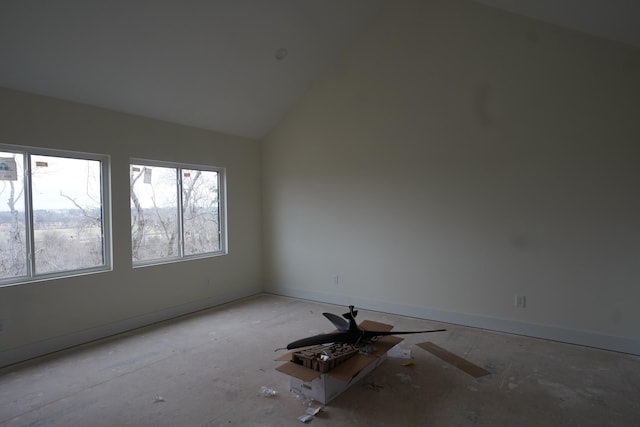 empty room with ceiling fan and lofted ceiling