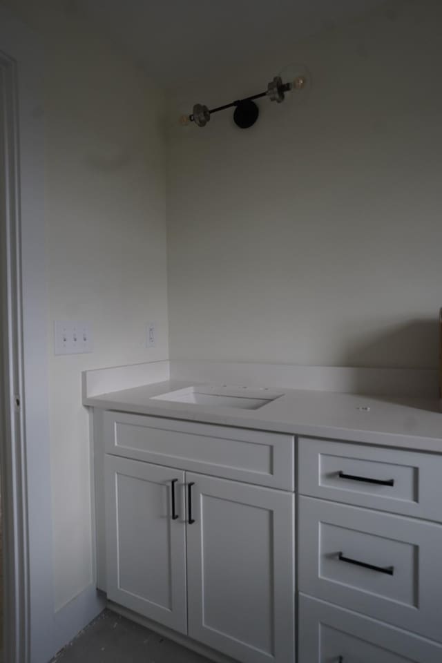 bathroom featuring concrete flooring and vanity