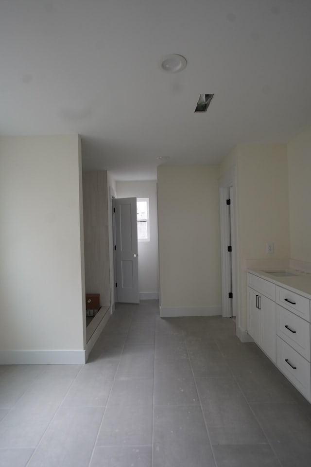 hallway featuring light tile patterned floors