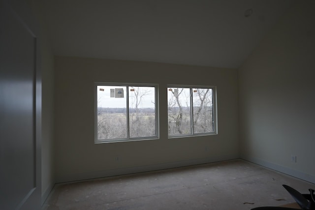 unfurnished room with vaulted ceiling