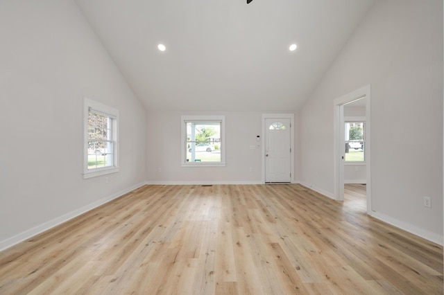 interior space featuring light wood-type flooring and lofted ceiling