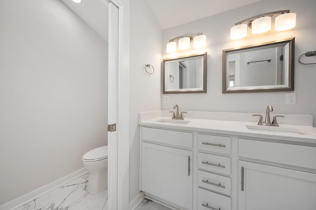 bathroom featuring vanity and toilet