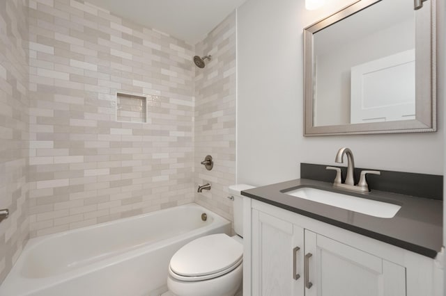 full bathroom with vanity, toilet, and tiled shower / bath